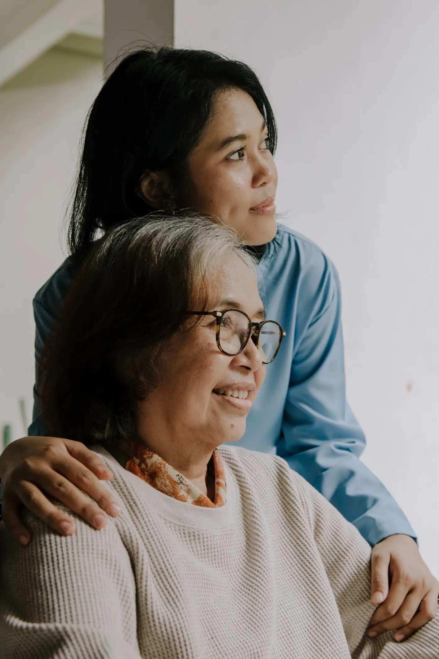 Adult daughter supporting an elderly parent at home